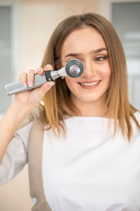 Portrait of young woman with eyes closed headphones