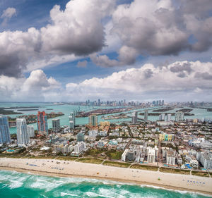 High angle view of buildings by sea against sky