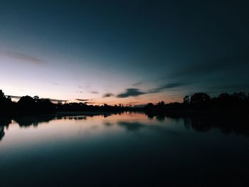 Scenic view of lake against sky at sunset