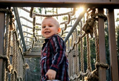 Portrait of boy standing in jungle gym