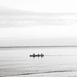 Boat sailing in sea against sky