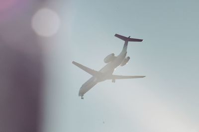 Low angle view of airplane flying in sky