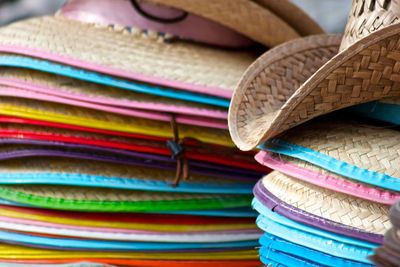 Stack of straw hats for sale