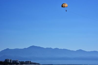 Low angle view of hot air balloon against clear blue sky