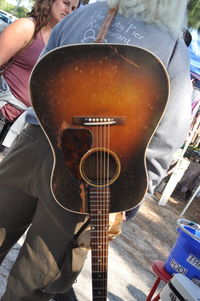 Midsection of woman playing guitar