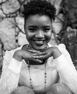 Portrait of a smiling young woman sitting outdoors