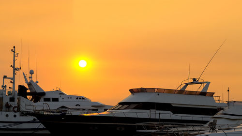 Sailboats in marina at sunset