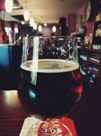 Close-up of beer glass on table