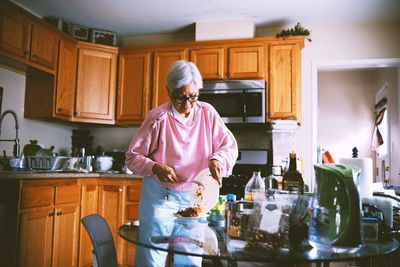 Portrait of an old woman in the kitchen