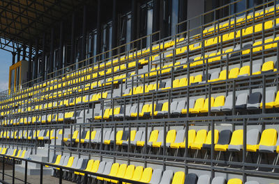 Empty plastic colored seats in stadium without spectators. water arena. side view.