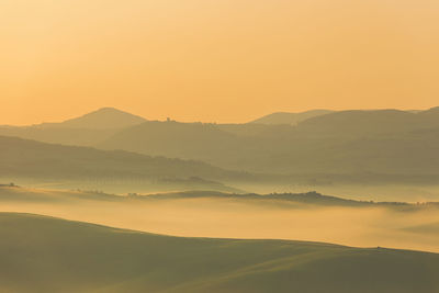 Scenic view of mountains against sky during sunset