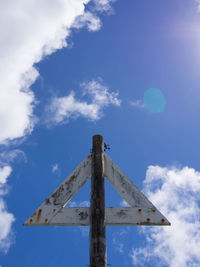 Low angle view of windmill against sky