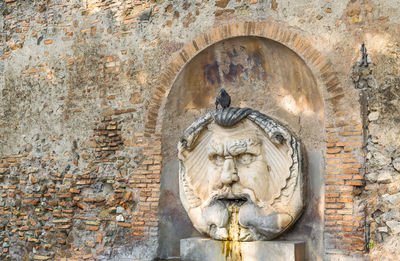 Statue of buddha on wall