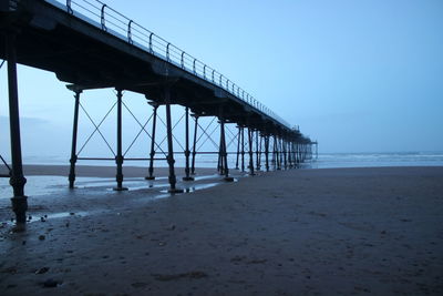 Pier over sea against clear sky