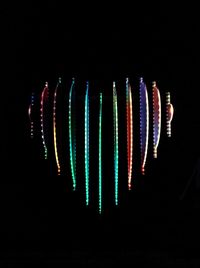 Close-up of multi colored lights over black background