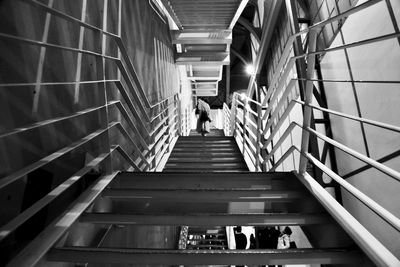 People walking on staircase in building