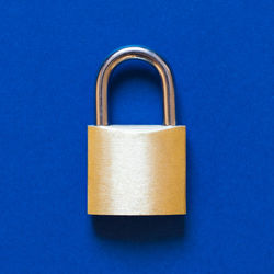 Directly above shot of padlock on blue background