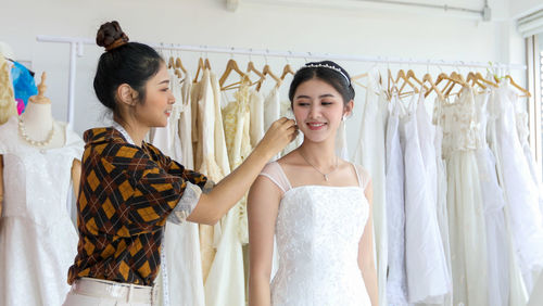 Happy young woman standing on display at store