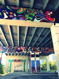 Low angle view of multi colored decorations hanging on building