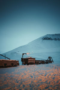 Train on field against clear blue sky