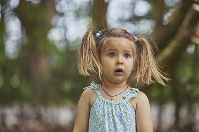 Portrait of young woman standing outdoors