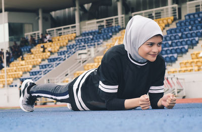 Athlete wearing hijab while exercising on sports track