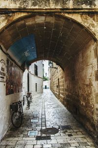 Empty alley amidst buildings in city