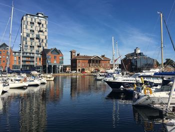 Sailboats moored in harbor