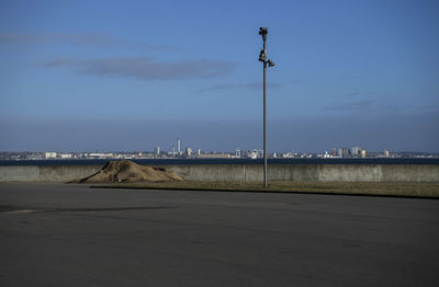 Road by sea against sky in city