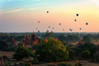 Hot air balloons against sky at sunset