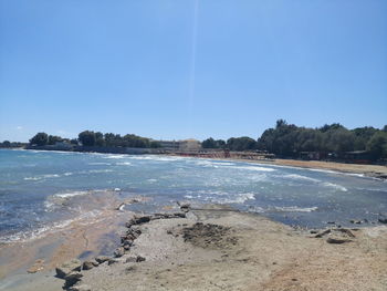 View of calm sea against clear blue sky