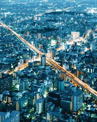 High angle view of illuminated cityscape at dusk