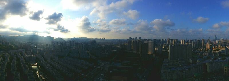 Cityscape against cloudy sky