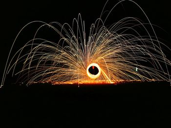 Wire wool against sky at night