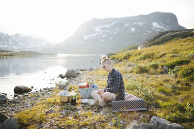 Woman camping at lake in mountains