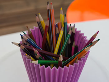 Close-up of multi colored pencils in container