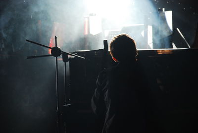 Rear view of silhouette man standing on stage