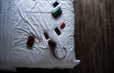 Directly above shot of personal accessories on bed at home