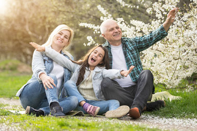 Portrait of happy family sitting in park