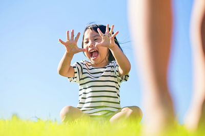 Close-up of girl playing on field