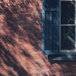 Shadow of window on brick wall of building