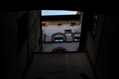 Buildings against sky seen through window