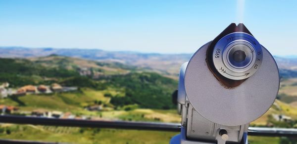 Close-up of coin-operated binoculars against sky