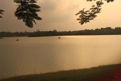 Scenic view of lake against sky during sunset