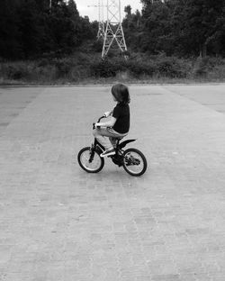 Woman riding bicycle on road
