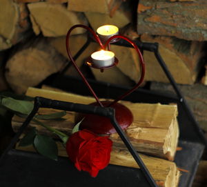 Tea light candles on heart shaped holder with red rose