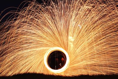 Low angle view of illuminated lighting equipment at night