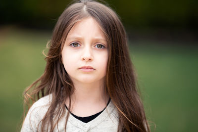 Close-up portrait of cute girl with hazel eyes in park