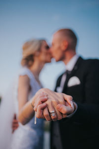 Midsection of couple holding hands