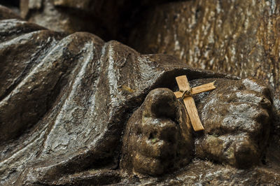 Cross on cropped jesus christ statue